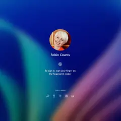 Ekran logowania Windows Hello z uśmiechniętą Robin Counts. Zeskanuj palec, by się zalogować.