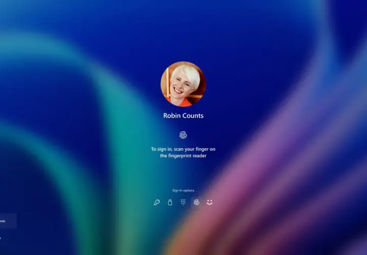 Ekran logowania Windows Hello z uśmiechniętą Robin Counts. Zeskanuj palec, by się zalogować.