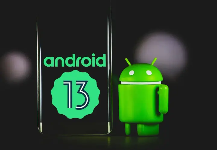 Zielony robot Android obok ekranu z napisem "android 13".