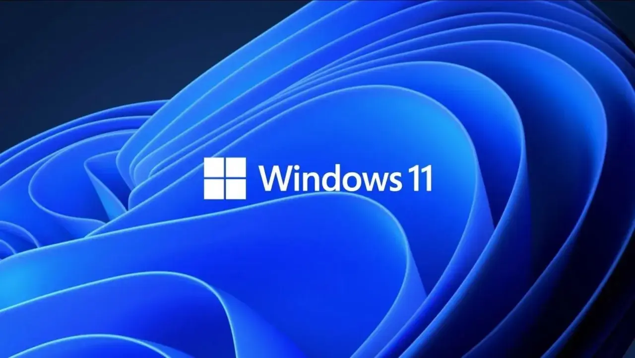 Niebieskie, faliste tło z białym logo i napisem "Windows 11". Ten klucz Windows 11 otwiera drzwi do nowoczesnego systemu.